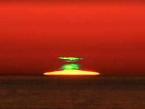 Breathtaking view of the rare Green Flash phenomenon at sunset, captured during a sunset cruise with Lightly Salted Charters in the serene waters of Islamorada, Florida Keys.